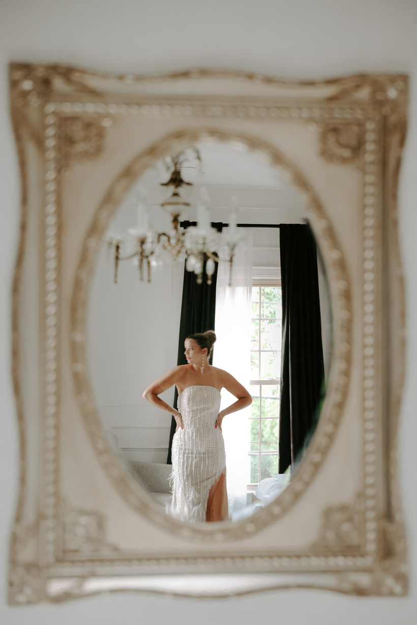 bride's reflection in mirror with gold frame