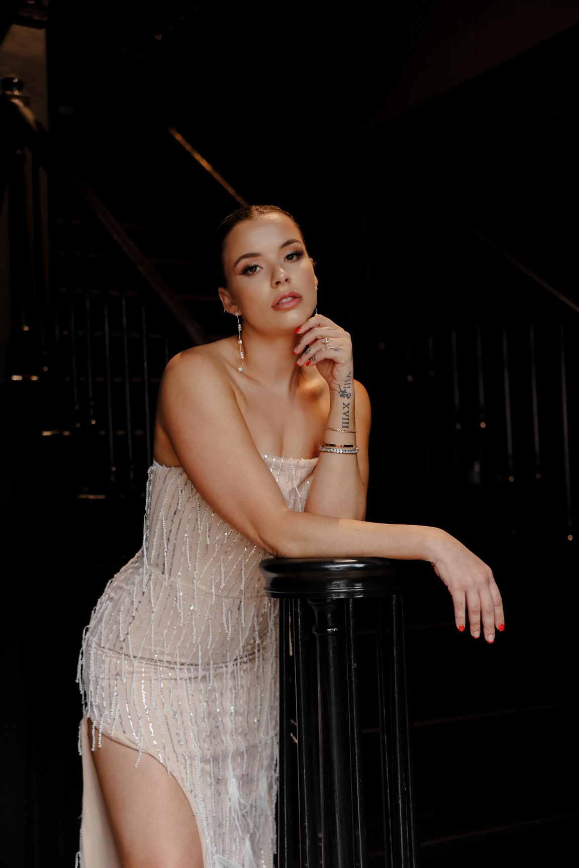 a person in a white dress sitting on a chair